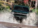 Green Jeep Splashing Through Shallow Water