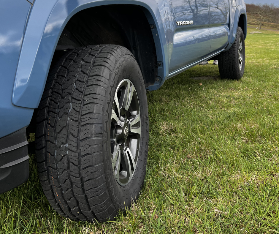 Blue Tacoma Featuring MT-X Tires Parked on Green Grass